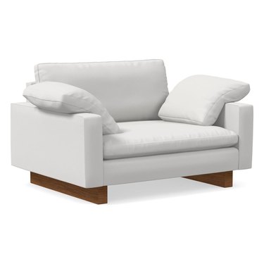plush white chair with wood plank legs