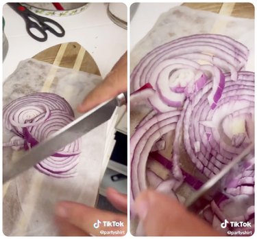 Slicing a red onion on a damp paper towel