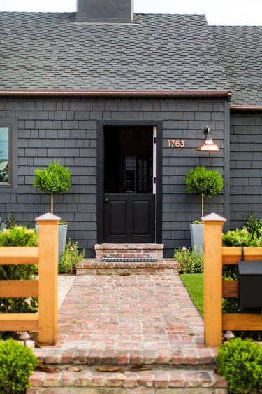 charcoal gray shingle siding with black roof and black front door