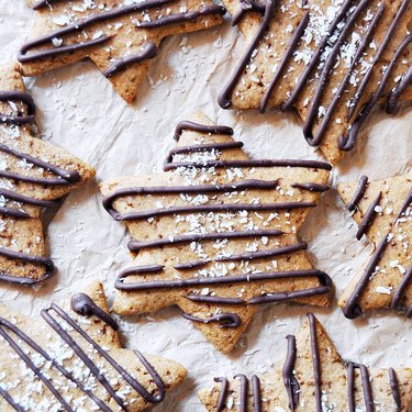 Vegan star cookies with a chocolate drizzle on a white background.