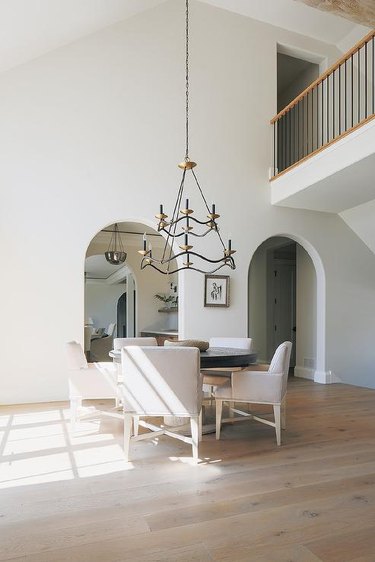 dining room with light gray walls and high ceiling