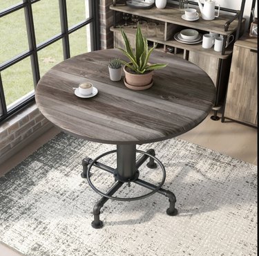Image of an industrial style dining table with fire-hydrant inspired legs and a wooden tabletop.