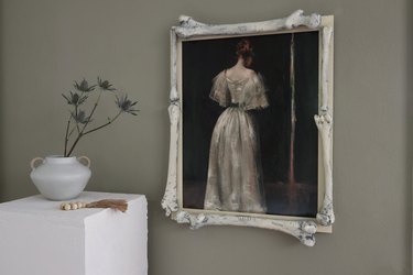 Moody portrait of woman in white gown framed with plastic bones