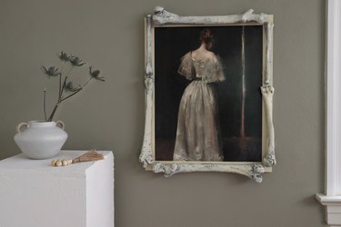 Moody portrait of woman in white gown framed with plastic bones