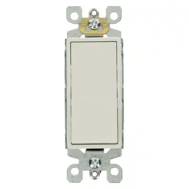 A white three-way light switch on a brighter white background.