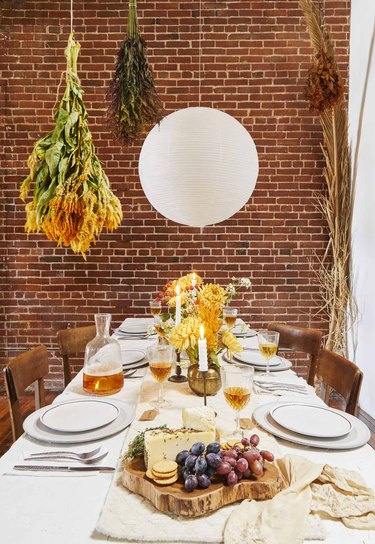 rustic dining table with exposed brick feature wall