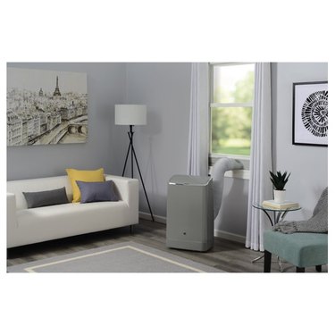 GE portable air conditioner in gray and white living room