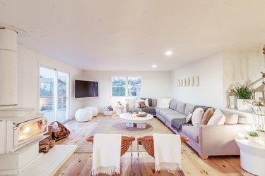 a large airy living room with a very long sectional couch running the length of one wall