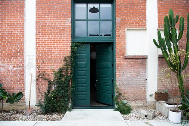 Green door in red brick entryway