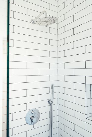 Shower with white horizontal subway tile and silver shower head