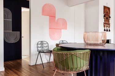 pink room ideas with pink abstract art, rose gold chair with green cushion.