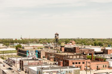 Distance view of city with industrial brick buildings and water tower