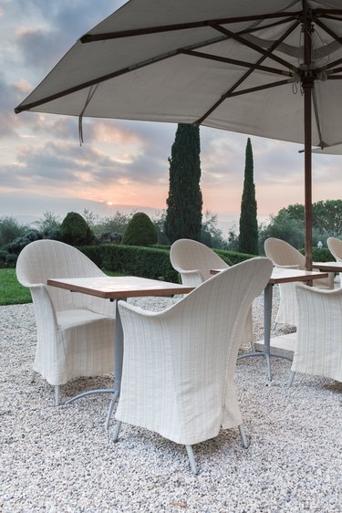 Outdoor white patio dining tables at dusk