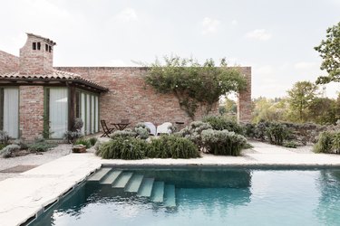 Pool house and pool with stone staircase