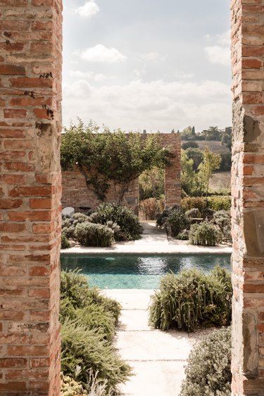 View of pool through brick archway