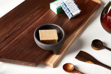 Wood cutting board with soap and wood spoons