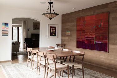 Midcentury dining room with wood paneled walls