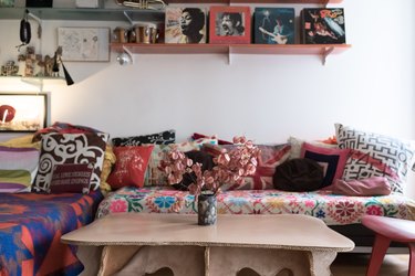 coffee table made from corrugated cardboard by Joel Stearns and bright patterns on couch in bohemian living room