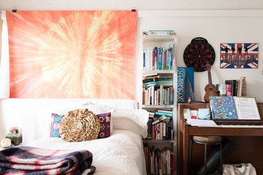 orange tie-dye tapestry in teen girl's bedroom