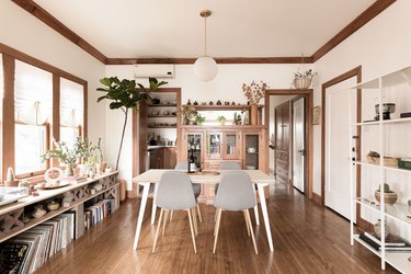 eco-friendly home design with minimalist dining room with a wooden table, pendant lamp and grey Eames chairs