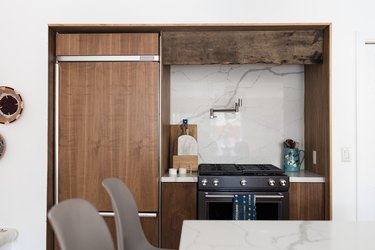 Kitchen with wood cabinets, and a marble or granite backsplash.