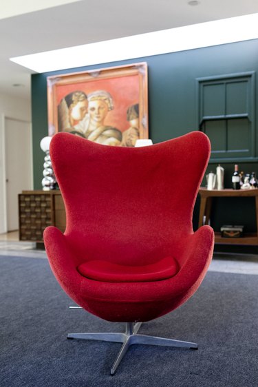 A red wing accent chair, on a gray rug.