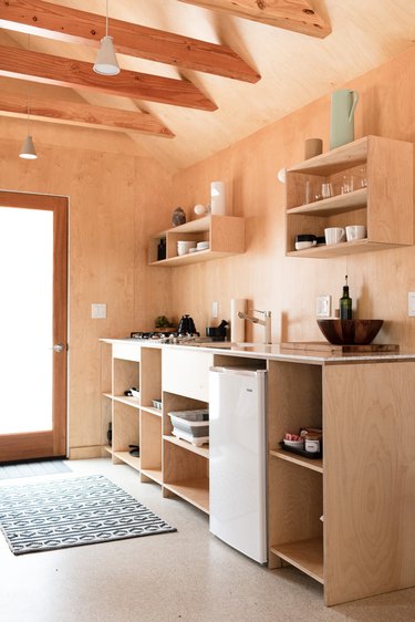 A wood-walled kitchen with wood cabinets