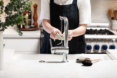 Hand washing dish cloth at kitchen sink