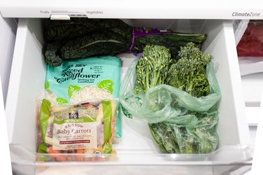 vegetable drawer in the refrigerator with carrots and cauliflower