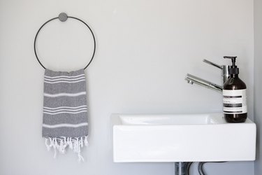 small sink with turkish hand towel and aesop hand soap