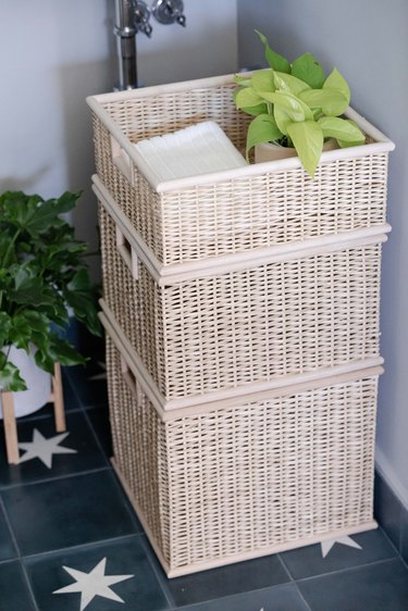 woven basket storage in bathroom with potted plant