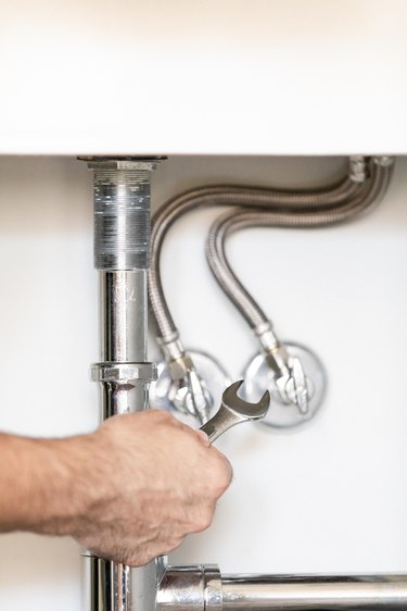 plumbing for bathroom sink with wrench