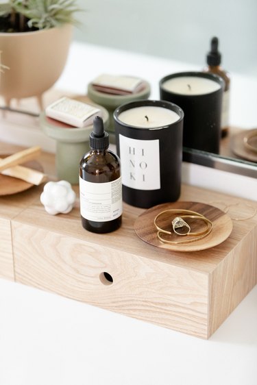 plywood storage box and candle and jewelry dish and skincare bottle