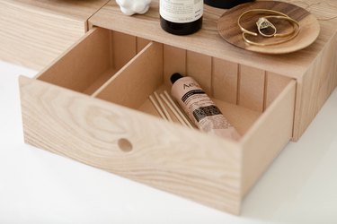 plywood storage with jewelry dish and skincare products