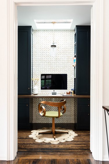 modern office nook with floating desk shelf and apple monitor