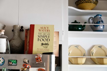 cookbook in kitchen with open shelving