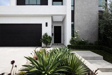 A black and white modern home and a garden