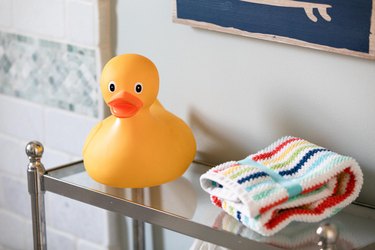 Rubber ducky on bathroom shelf