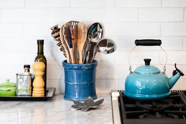 blue kettle and blue utensil holder