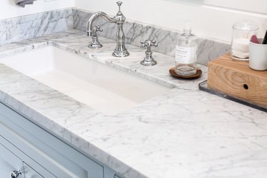 Marble countertop, white undermount sink, silver faucet and handles