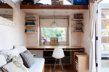 A bedroom window with Roman shades