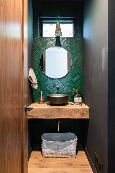 Green tiled basement bathroom idea with a wood counter and flooring with small window