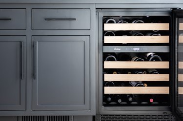 Gray cabinets with a  built-in wine cooler