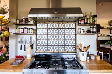 Boho styled blue and white tiled stove backsplash.