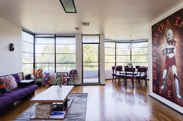 Living room with wood floors, large windows and contemporary art