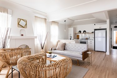 living room with fireplace connected with white kitchen