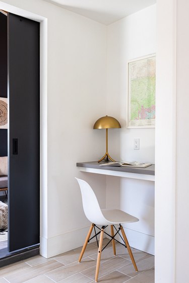 modern home office in a small nook, including a wall mount desk and chair