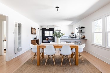 rectangular wood dining table over natural jute rug