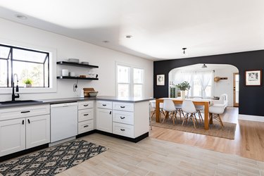 dining room wall decor idea for white kitchen with white-black cabinets and wood floors