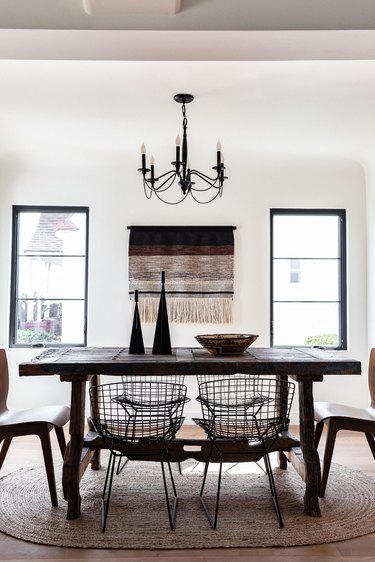 White-walled dining room with wood dining furniture and black-beige accents